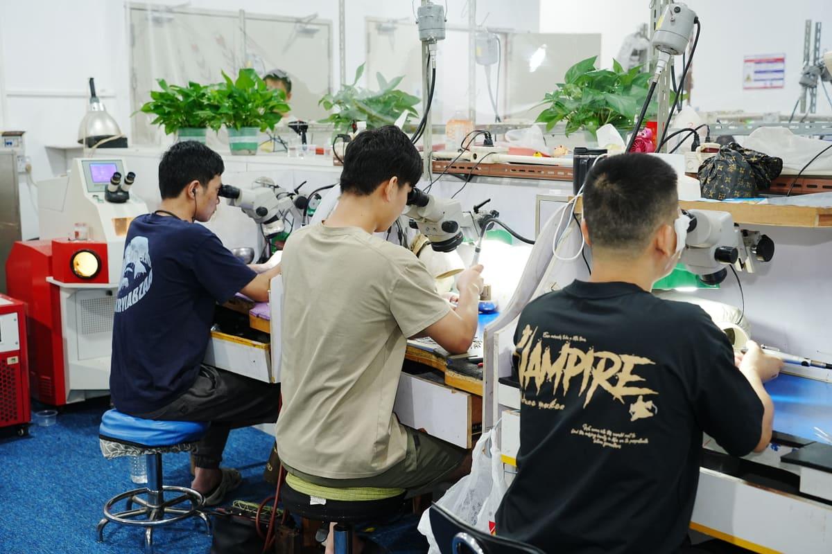 Setters at microscopes on the CLARVEO production floor